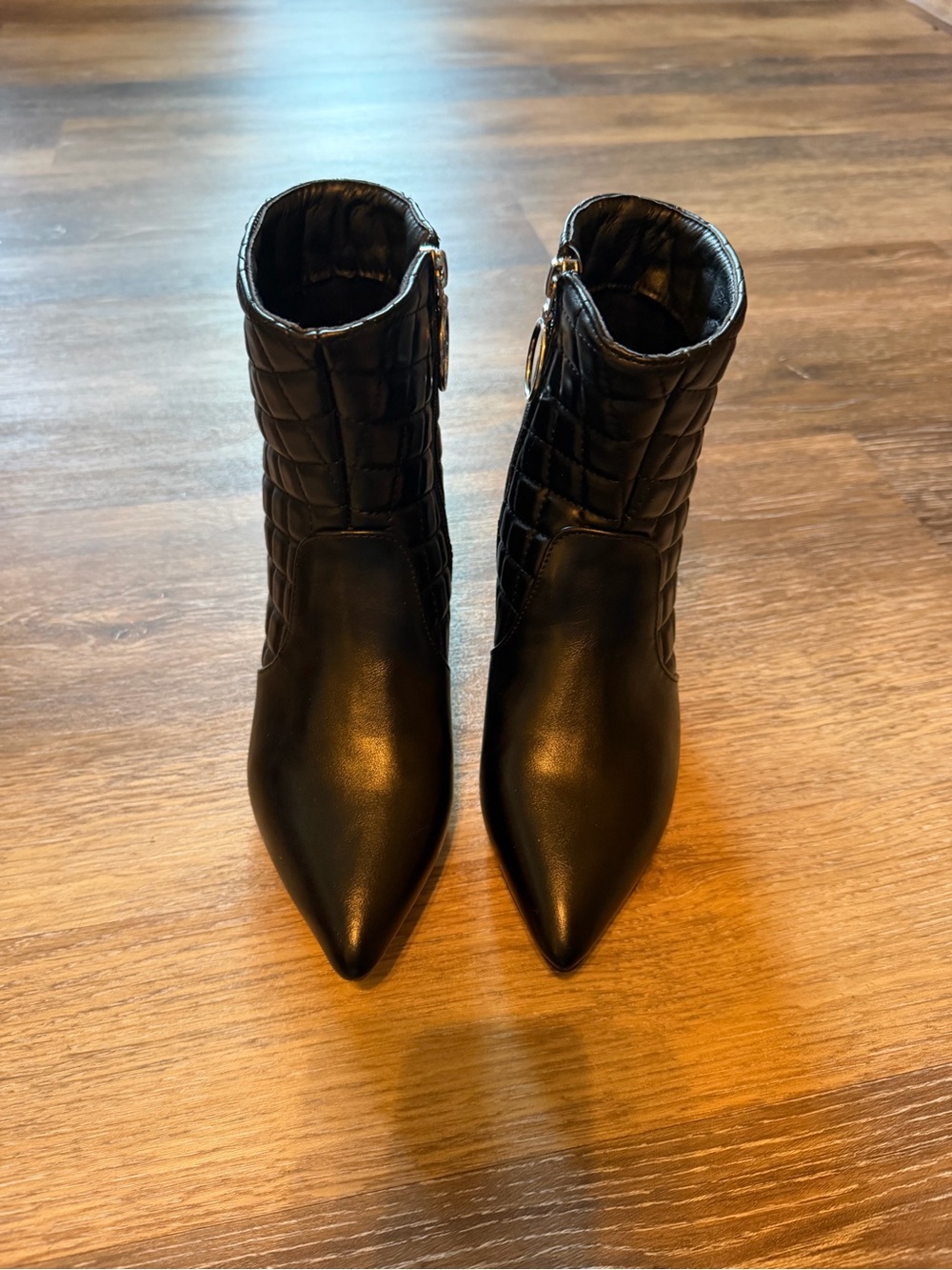 Trary Black Quilted Pointed Toe Ankle Booties with Ring Zip Accent